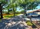 Scenic street view of townhomes and well-maintained lawns with mature trees and parked cars at 2348 Sun Valley Cir, Winter Park, FL 32792