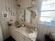 Double sink bathroom with wallpaper and a large mirror at 240 Slade Dr, Longwood, FL 32750