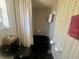 Retro bathroom featuring black fixtures and patterned wallpaper at 240 Slade Dr, Longwood, FL 32750