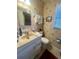 Bathroom with beige sink, toilet and lighthouse-themed wallpaper at 240 Slade Dr, Longwood, FL 32750