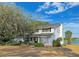 Charming two-story home with a brick facade and a well-maintained yard overlooking a serene lake at 240 Slade Dr, Longwood, FL 32750