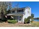 Two-story home with white siding, brick accents, bay window, and mature landscaping at 240 Slade Dr, Longwood, FL 32750