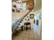 Welcoming foyer with staircase and decorative table, tiled floor, and access to other rooms at 240 Slade Dr, Longwood, FL 32750