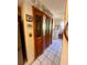 Hallway with bi-fold doors leading to a laundry area and kitchen, with decorative plates at 240 Slade Dr, Longwood, FL 32750