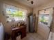 Laundry room with tile floor, window and door leading to outdoors at 240 Slade Dr, Longwood, FL 32750