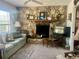 Cozy living room with a stone fireplace, mantle, and comfortable seating at 240 Slade Dr, Longwood, FL 32750