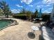Outdoor patio area with furniture, umbrella, and views of the backyard and water at 240 Slade Dr, Longwood, FL 32750