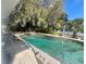 Outdoor swimming pool surrounded by trees and foliage on a sunny day at 240 Slade Dr, Longwood, FL 32750
