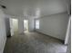 Bright bedroom with en-suite bathroom, plush carpeting, and large window at 2435 W Park Dr., Deland, FL 32724