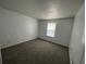A view of the bedroom featuring carpeted flooring and a window with natural light at 2435 W Park Dr., Deland, FL 32724