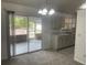 Cozy kitchen with white cabinets, and sliding glass doors to patio at 2435 W Park Dr., Deland, FL 32724