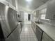 Modern kitchen featuring stainless steel appliances, tile floors, and ample cabinet space at 2435 W Park Dr., Deland, FL 32724