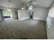 Spacious living room featuring plush carpeting, vaulted ceilings, and ample natural light at 2435 W Park Dr., Deland, FL 32724