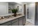Modern bathroom with double vanity, granite countertops, and a walk-in shower at 2604 Grandbury Grove Rd, Lakeland, FL 33811