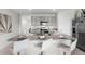 Bright kitchen features a large island with granite countertops, seating, and stainless steel appliances at 2604 Grandbury Grove Rd, Lakeland, FL 33811
