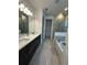 Well lit bathroom with dual vanities, tile floor, soaking tub and walk-in shower at 2741 Nottel Dr, St Cloud, FL 34772