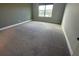Neutral bedroom with plush carpet, a window and grey walls at 2741 Nottel Dr, St Cloud, FL 34772