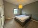 Bedroom with gray walls, window, carpet, and unique hanging light fixture at 2741 Nottel Dr, St Cloud, FL 34772