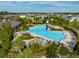 Aerial view of a community pool with a slide, lounging area and mature landscaping at 2741 Nottel Dr, St Cloud, FL 34772