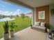 Inviting covered patio with comfortable seating and serene views of the lake and surrounding community at 2741 Nottel Dr, St Cloud, FL 34772