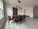 Stylish dining room with modern furniture and a striking light fixture at 2741 Nottel Dr, St Cloud, FL 34772