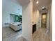 Bright hallway view leading to an adjacent living room and a bathroom, enhanced by neutral tile flooring at 2741 Nottel Dr, St Cloud, FL 34772