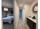 Hallway leading to a bedroom with modern decor and ample natural light at 2741 Nottel Dr, St Cloud, FL 34772