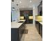 Modern kitchen featuring stainless steel appliances, dark cabinetry, and a spacious island with quartz countertops at 2741 Nottel Dr, St Cloud, FL 34772