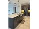 Modern kitchen featuring stainless steel appliances, dark cabinetry, and a spacious island with quartz countertops at 2741 Nottel Dr, St Cloud, FL 34772