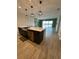 The open concept kitchen has an island with stainless steel appliances and sliding glass doors with a lake view at 2741 Nottel Dr, St Cloud, FL 34772