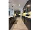 Modern kitchen with dark cabinets, stainless steel appliances, and subway tile backsplash at 2741 Nottel Dr, St Cloud, FL 34772