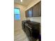 Laundry room featuring modern washer and dryer, with matching cabinets at 2741 Nottel Dr, St Cloud, FL 34772