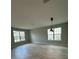 Bright, open living room with tiled floors and two large windows offering natural light at 2741 Nottel Dr, St Cloud, FL 34772