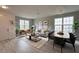 Open-concept living room with hardwood floors, modern furnishings, and abundant natural light at 2741 Nottel Dr, St Cloud, FL 34772