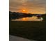 Stunning sunrise over a serene pond reflecting the surrounding homes and natural landscape at 2741 Nottel Dr, St Cloud, FL 34772