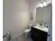 Elegant powder room with sleek fixtures, a modern vanity, and decorative accents at 2741 Nottel Dr, St Cloud, FL 34772