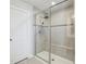 Modern bathroom featuring a glass shower with bench, light tile and sleek fixtures at 2965 Slough Creek Dr, Kissimmee, FL 34744