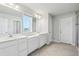 Bright bathroom with double vanities, tile floors, and a walk-in shower at 2965 Slough Creek Dr, Kissimmee, FL 34744