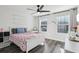 Cozy bedroom with wood floors, ceiling fan, two windows and cherry-themed bedspread at 2965 Slough Creek Dr, Kissimmee, FL 34744