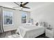 Bright bedroom with wood floors, ceiling fan, two windows, and white furniture at 2965 Slough Creek Dr, Kissimmee, FL 34744