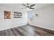 Bright bedroom features gray laminate flooring, a ceiling fan, and a window offering a view of the community pond at 2965 Slough Creek Dr, Kissimmee, FL 34744
