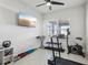 Home gym with TV, free weights, exercise bike, treadmill and bright natural light at 2965 Slough Creek Dr, Kissimmee, FL 34744