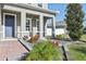 Charming front porch with decorative columns, colorful flowers, and a well-maintained walkway, welcoming guests at 2965 Slough Creek Dr, Kissimmee, FL 34744