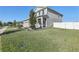 Well-manicured front yard with lush green grass, a tree, and elegant landscaping enhance the home's curb appeal at 2965 Slough Creek Dr, Kissimmee, FL 34744