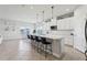 Bright kitchen with a large center island, white cabinets, and views of the dining area at 2965 Slough Creek Dr, Kissimmee, FL 34744