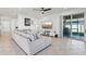 Inviting living room with a large sectional sofa, stylish decor, and sliding glass doors to the patio at 2965 Slough Creek Dr, Kissimmee, FL 34744