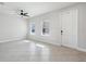 Bright living room with tile flooring, filled with natural light, and a ceiling fan at 2965 Slough Creek Dr, Kissimmee, FL 34744
