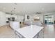 Open-concept living space with a kitchen island and dining area leading to a comfortable living room at 2965 Slough Creek Dr, Kissimmee, FL 34744