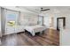 Serene primary bedroom with tray ceilings, hardwood floors, and abundant natural light at 2965 Slough Creek Dr, Kissimmee, FL 34744