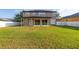 Expansive backyard featuring a large lawn, a white fence, and a covered patio at 305 Kays Landing Dr, Sanford, FL 32771